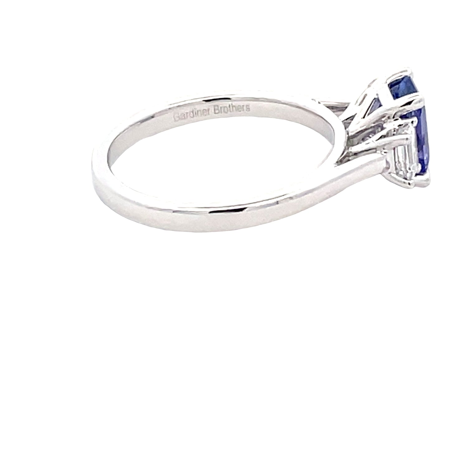Octagonal Shaped Tanzanite and emerald cut diamond 3 stone ring Gardiner Brothers