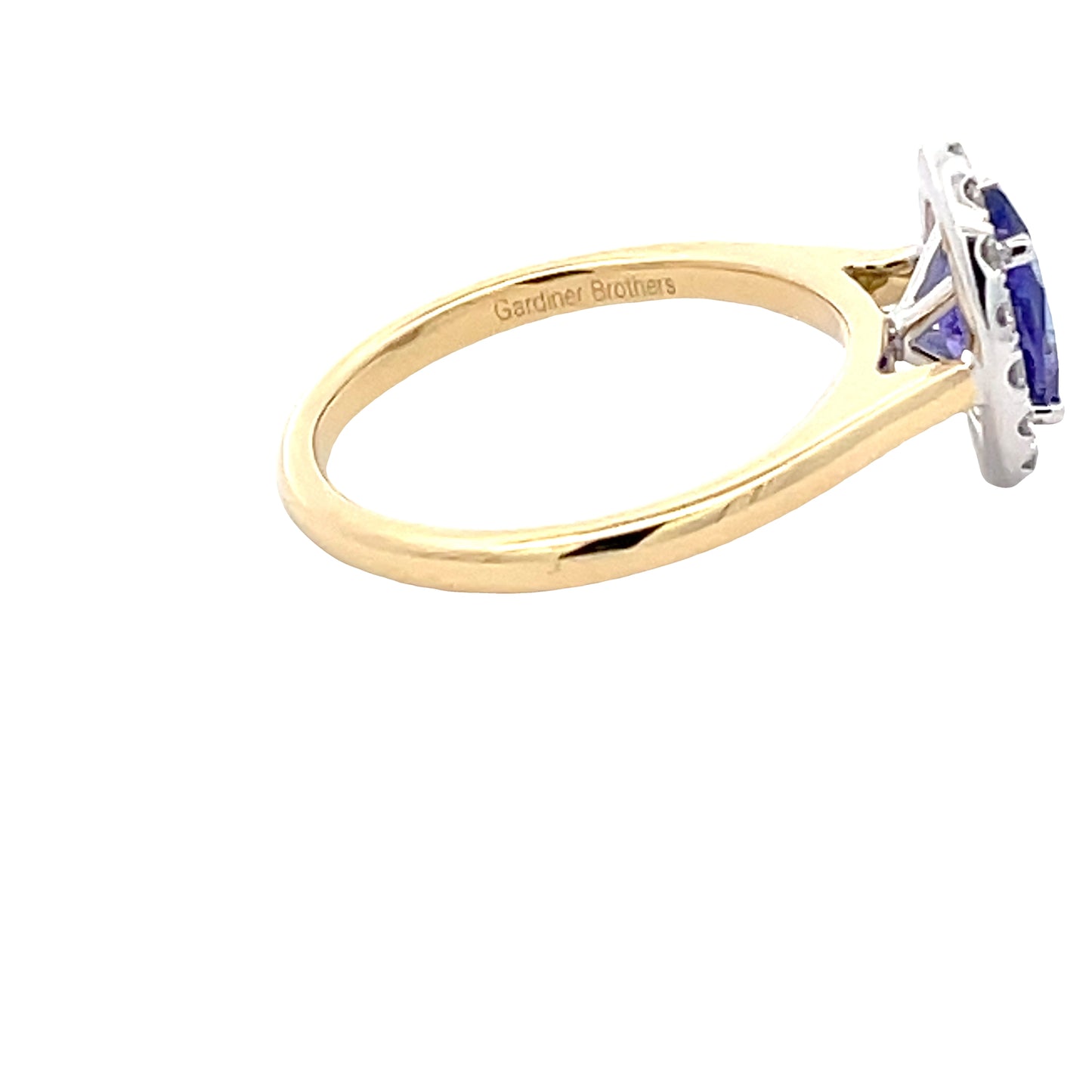 Oval Tanzanite and round brilliant cut diamond halo ring Gardiner Brothers