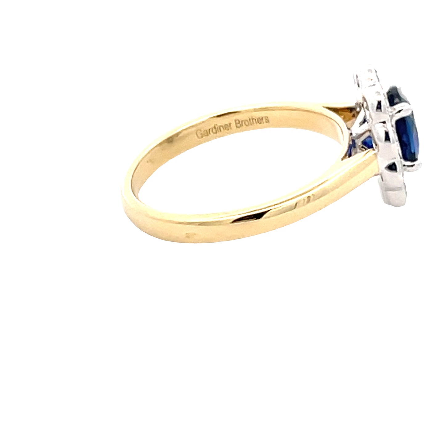 Oval Shaped Sapphire and Round Brilliant Cut Diamond Cluster Style Ring Gardiner Brothers