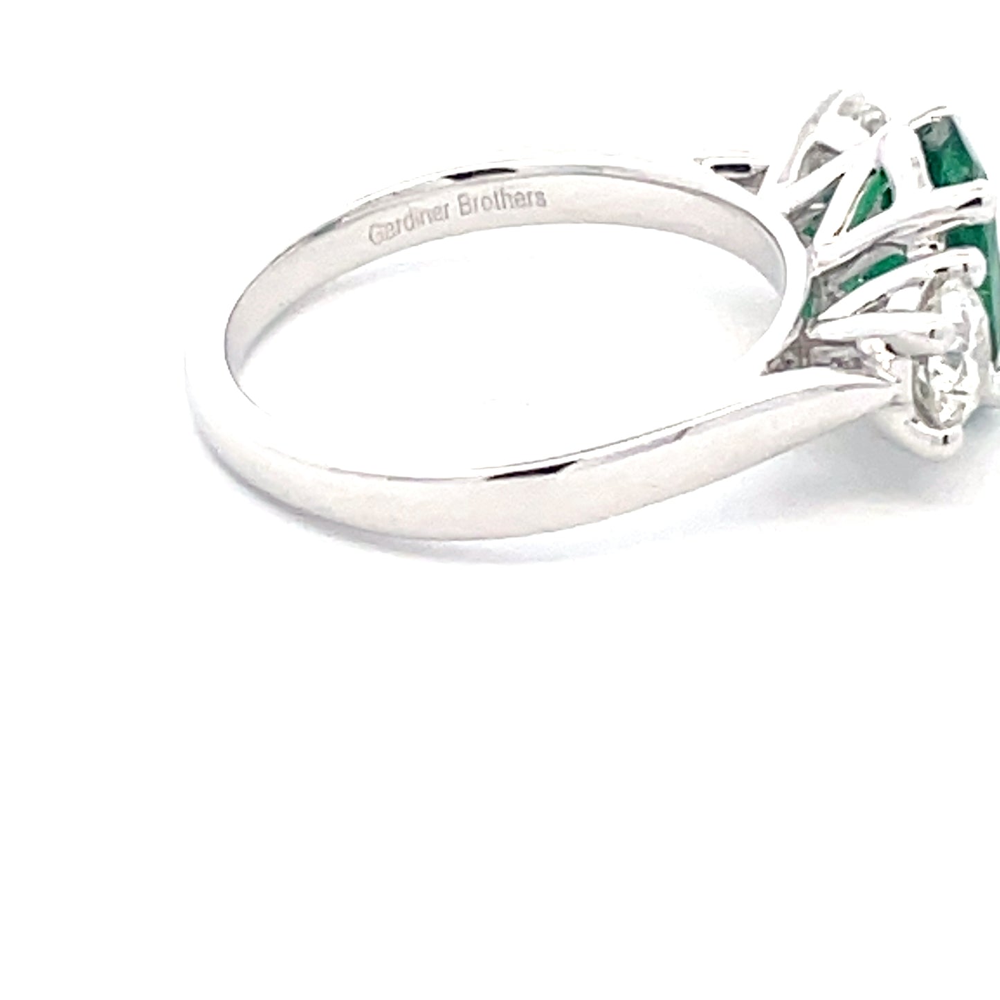 Oval Emerald and round brilliant cut diamond 3 stone ring Gardiner Brothers