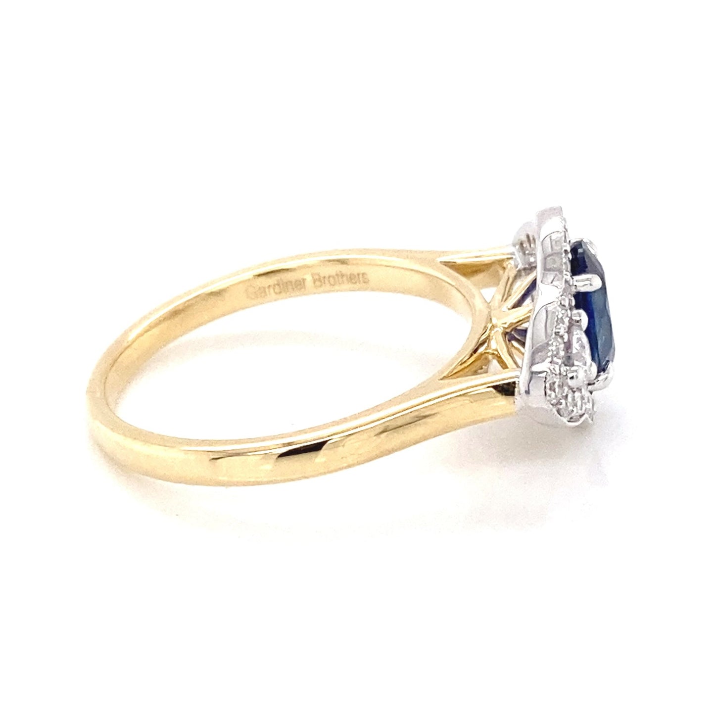 Oval Sapphire and round brilliant cut diamond fancy halo style ring Gardiner Brothers