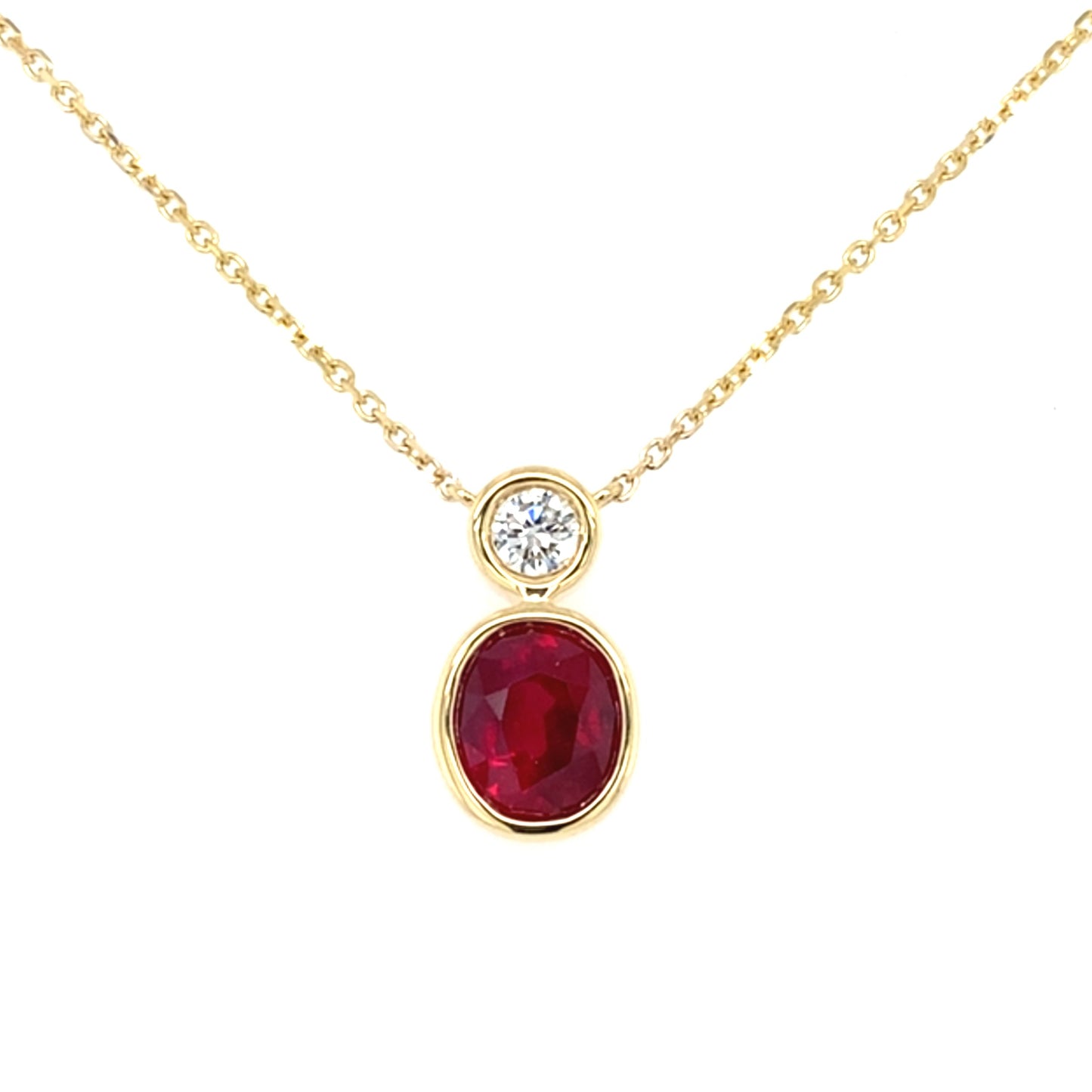 Oval Ruby and Round Brilliant cut diamond, rub-over drop style pendant Gardiner Brothers