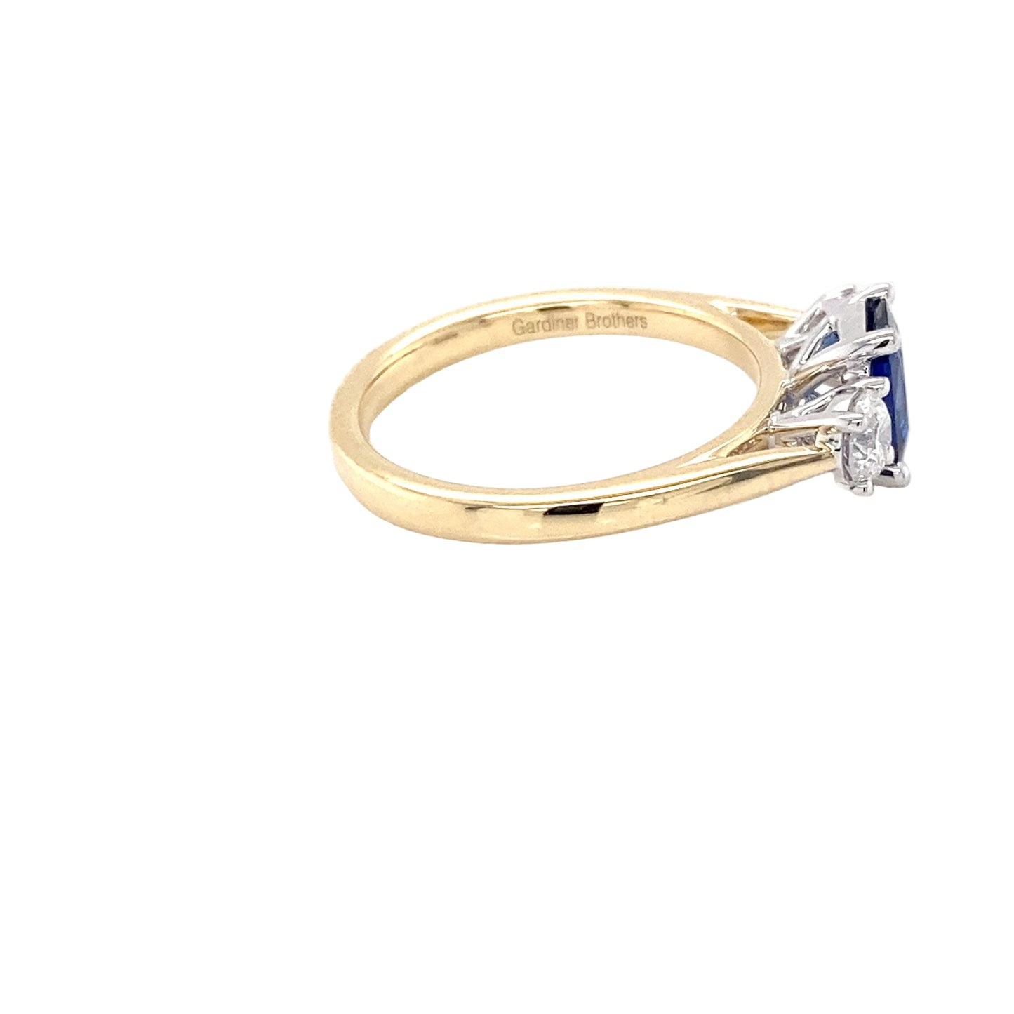 Cushion Shaped Sapphire and round brilliant cut diamond 3 stone ring Gardiner Brothers