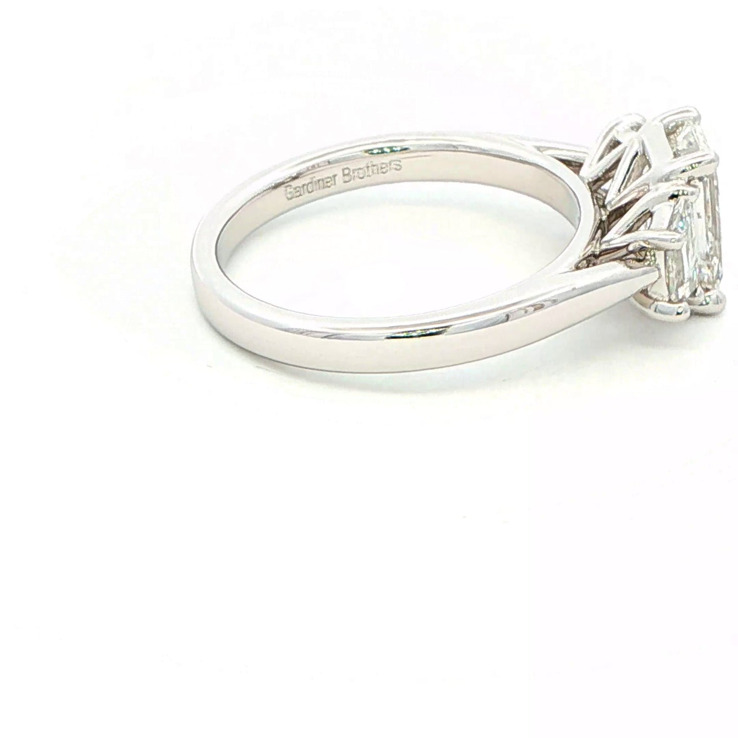 Emerald and Trapezoid cut diamond 3 stone ring - 2.00cts Gardiner Brothers