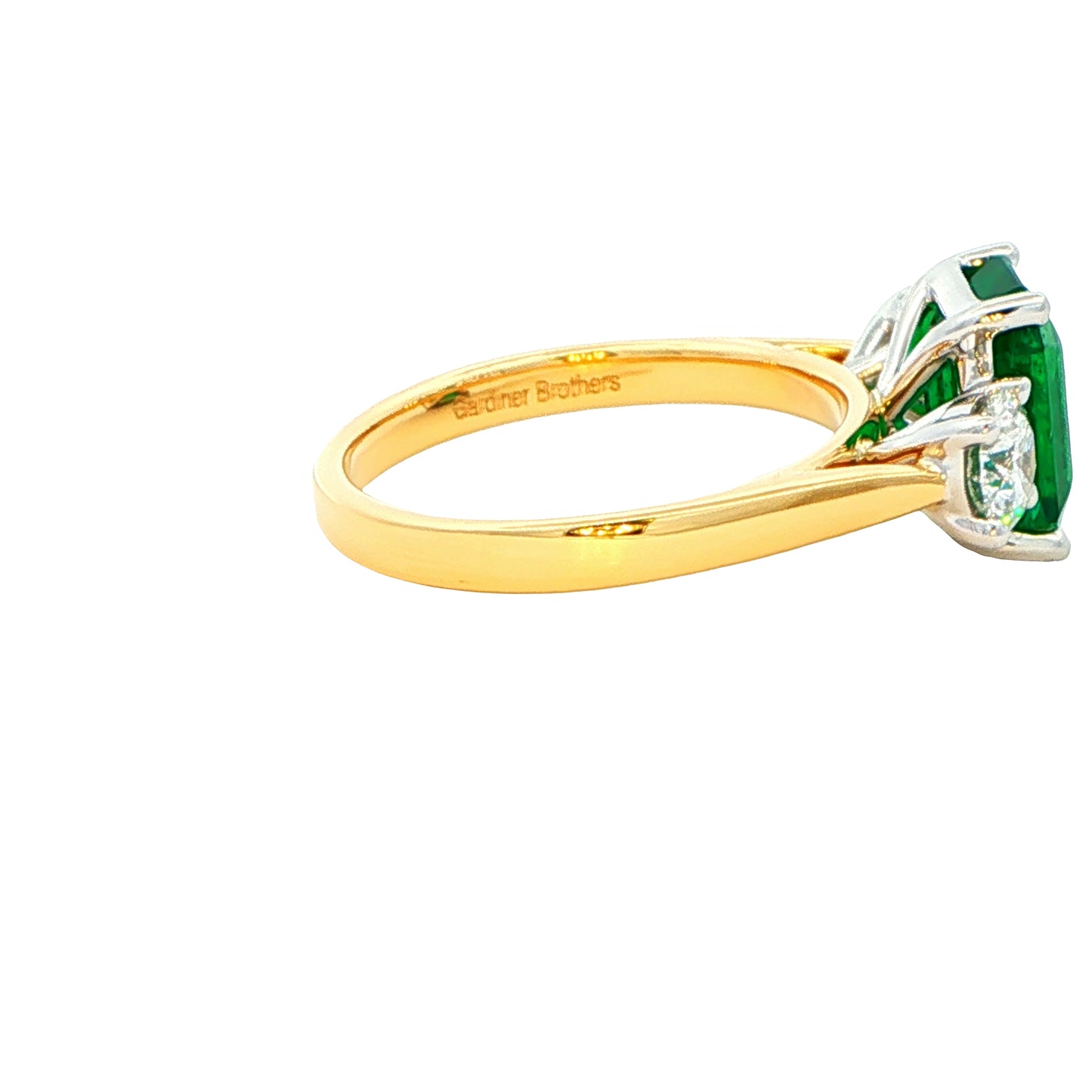 Octagonal shaped emerald and round brilliant cut diamond 3 stone ring Gardiner Brothers