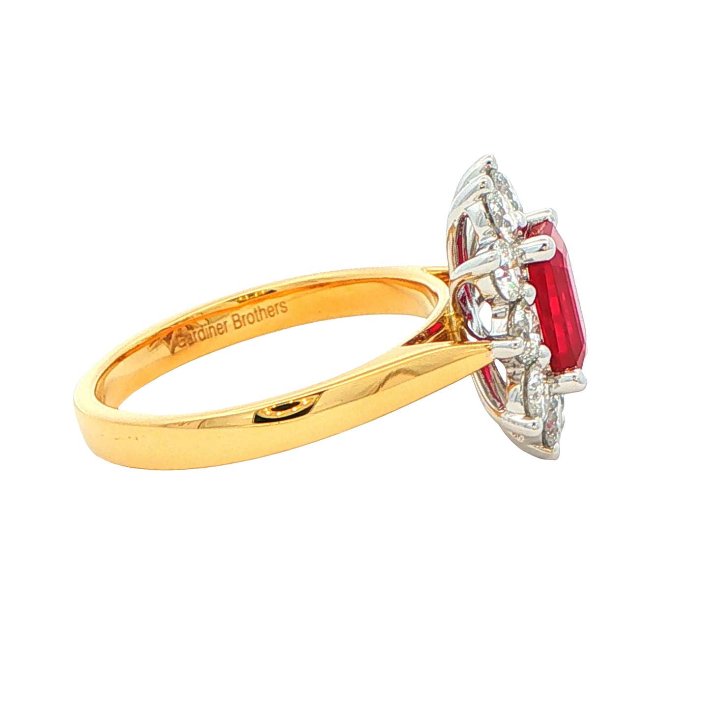 Octagonal shaped ruby and round brilliant cut diamond cluster style ring