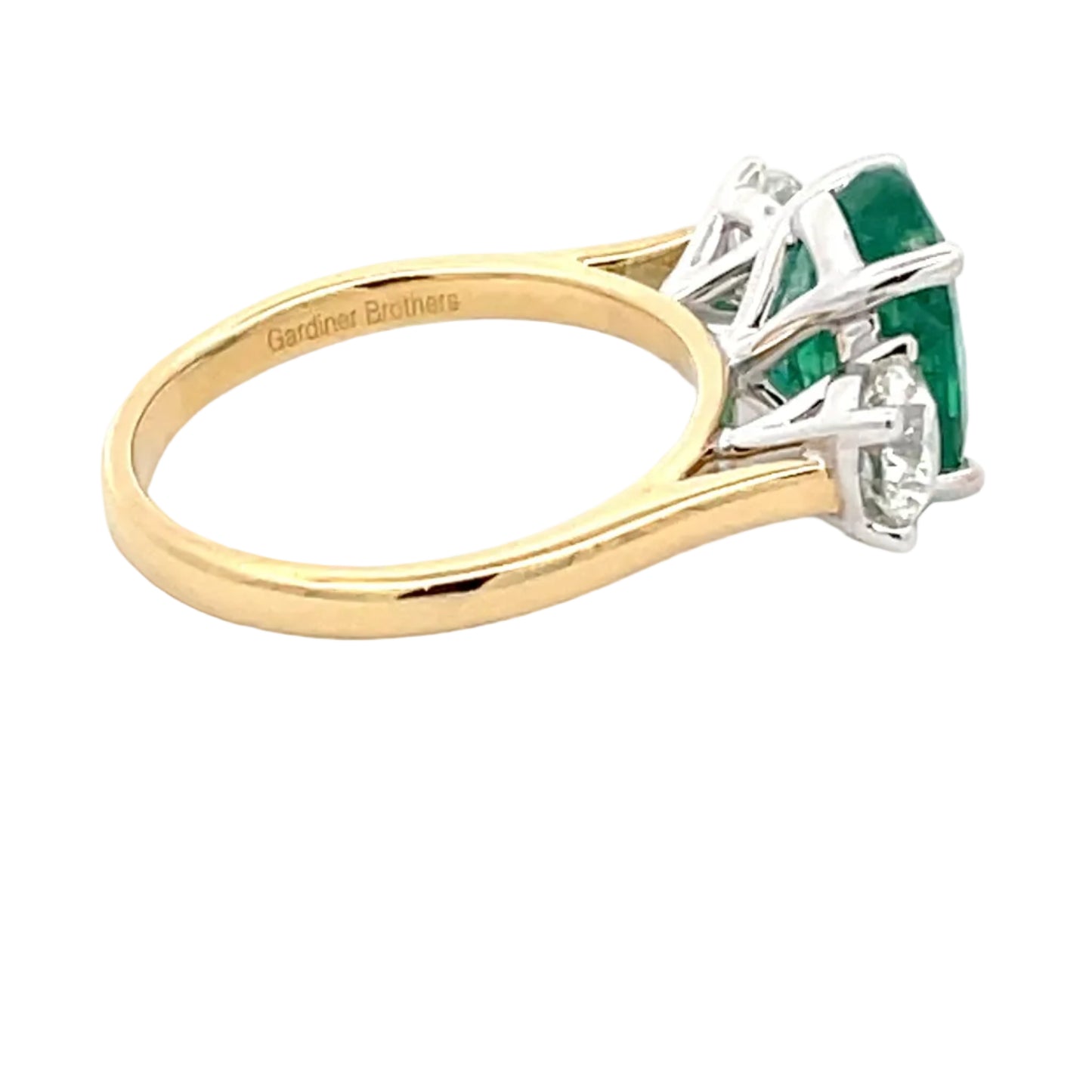 Emerald and round brilliant cut diamond 3 stone ring Gardiner Brothers