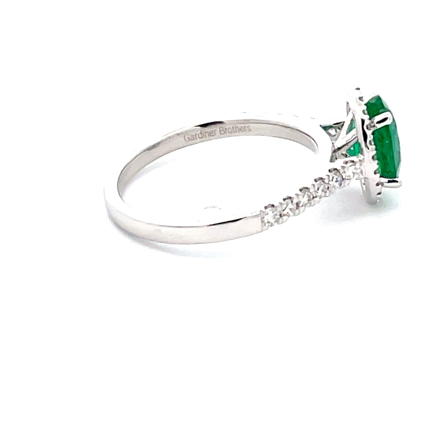 Emerald and round Brilliant Cut diamond halo style ring Gardiner Brothers