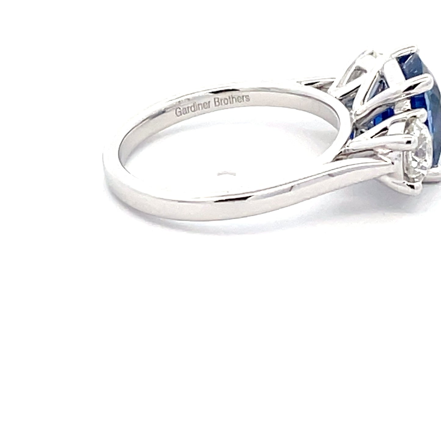 Cushion Shaped Sapphire and round brilliant cut diamond 3 stone ring  Gardiner Brothers   