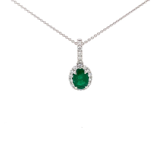 Oval emerald and round brilliant cut diamond halo style pendant