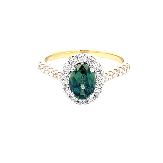 Oval Shaped Teal Sapphire and round brilliant cut diamond halo cluster style ring