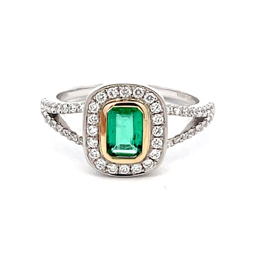Octagonal emerald with round brilliant cut diamond halo cluster style ring