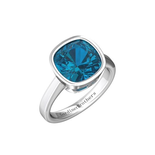 Nova cushion shaped London Blue Topaz ring set in a plain bezel setting Gardiner Brothers White Gold