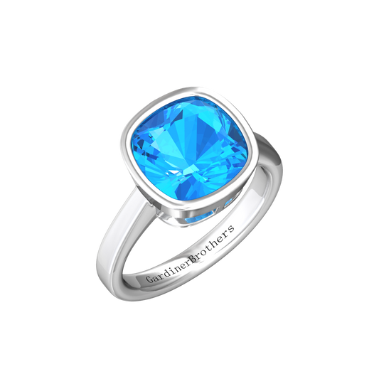 Nova cushion shaped Swiss Blue Topaz ring set in a plain bezel setting Gardiner Brothers White Gold