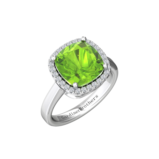 Nova cushion shaped Peridot ring with a halo of diamonds Gardiner Brothers White gold