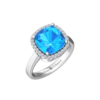 Nova cushion shaped Swiss Blue Topaz ring with a halo of diamonds Gardiner Brothers White Gold