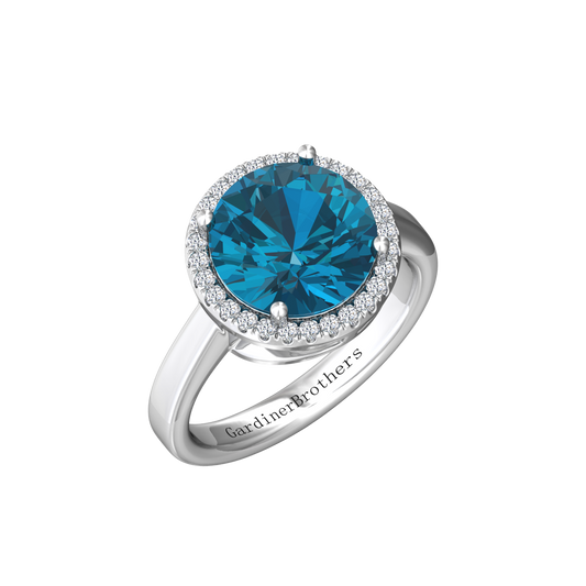 Nova round London Blue Topaz ring with a halo of diamonds Gardiner Brothers White Gold