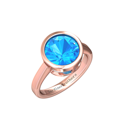 Nova round Swiss Blue Topaz ring set in a plain bezel setting Gardiner Brothers Rose Gold
