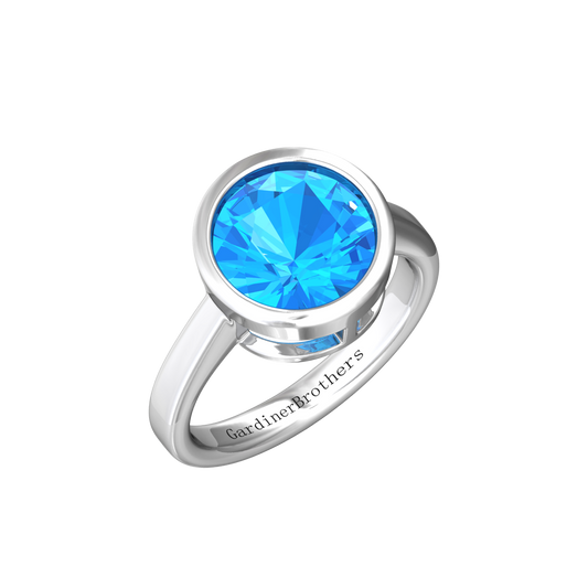 Nova round Swiss Blue Topaz ring set in a plain bezel setting Gardiner Brothers White Gold