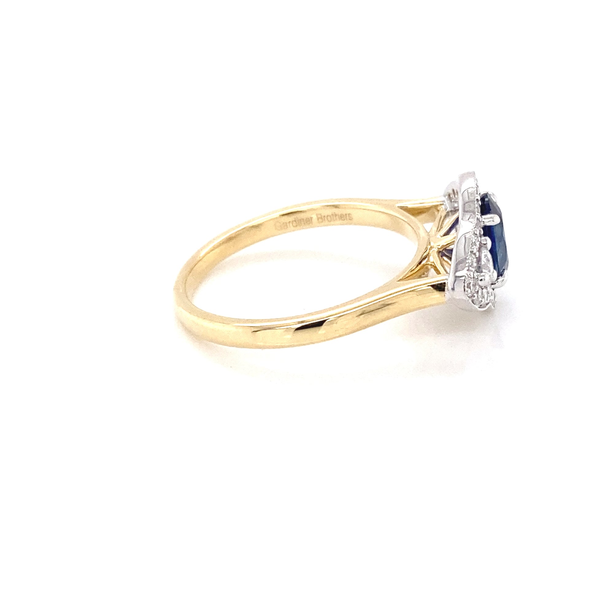 Oval Sapphire and round brilliant cut diamond fancy halo style ring Gardiner Brothers