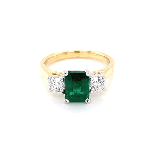 Octagonal emerald and round brilliant cut diamond 3 stone ring Gardiner Brothers