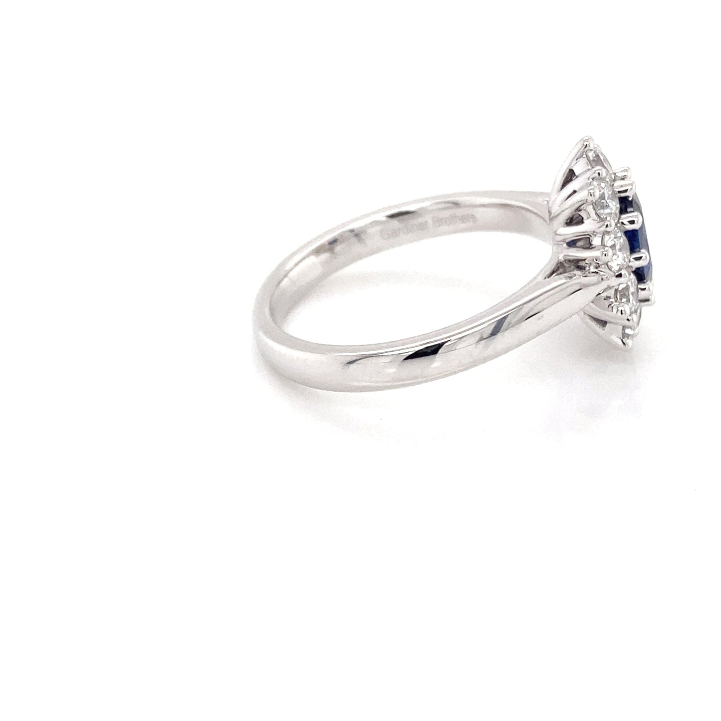 Oval shaped sapphire and round brilliant cut diamond cluster ring Gardiner Brothers