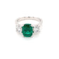 Cushion shaped emerald and round brilliant cut diamond 3 stone ring Gardiner Brothers