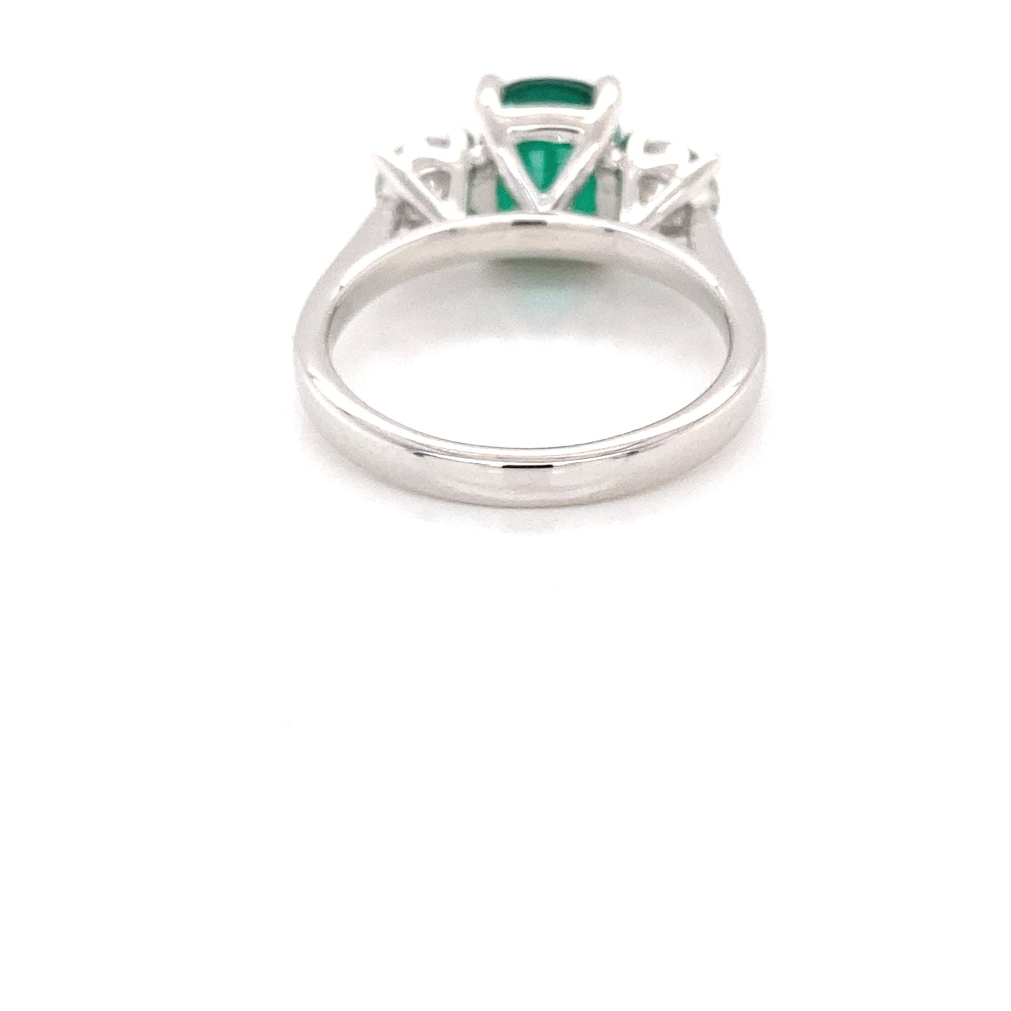 Cushion shaped emerald and round brilliant cut diamond 3 stone ring Gardiner Brothers