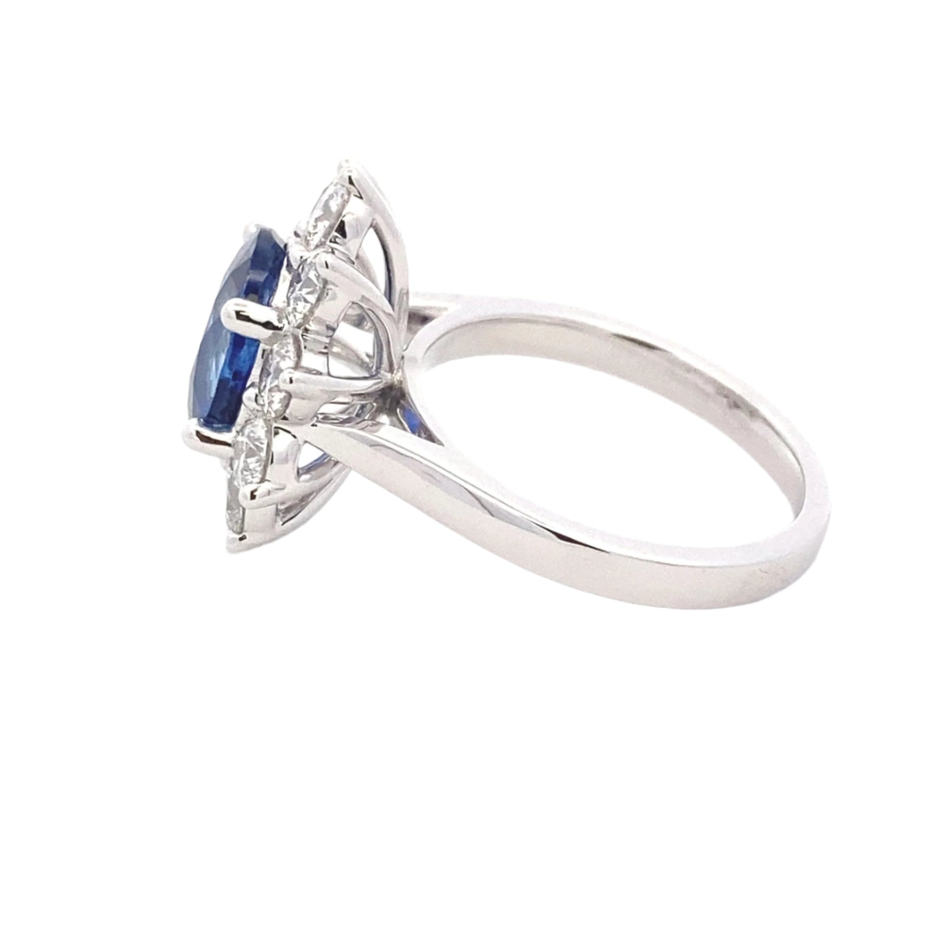 Oval Shaped Sapphire and round brilliant cut diamond traditional cluster ring Gardiner Brothers