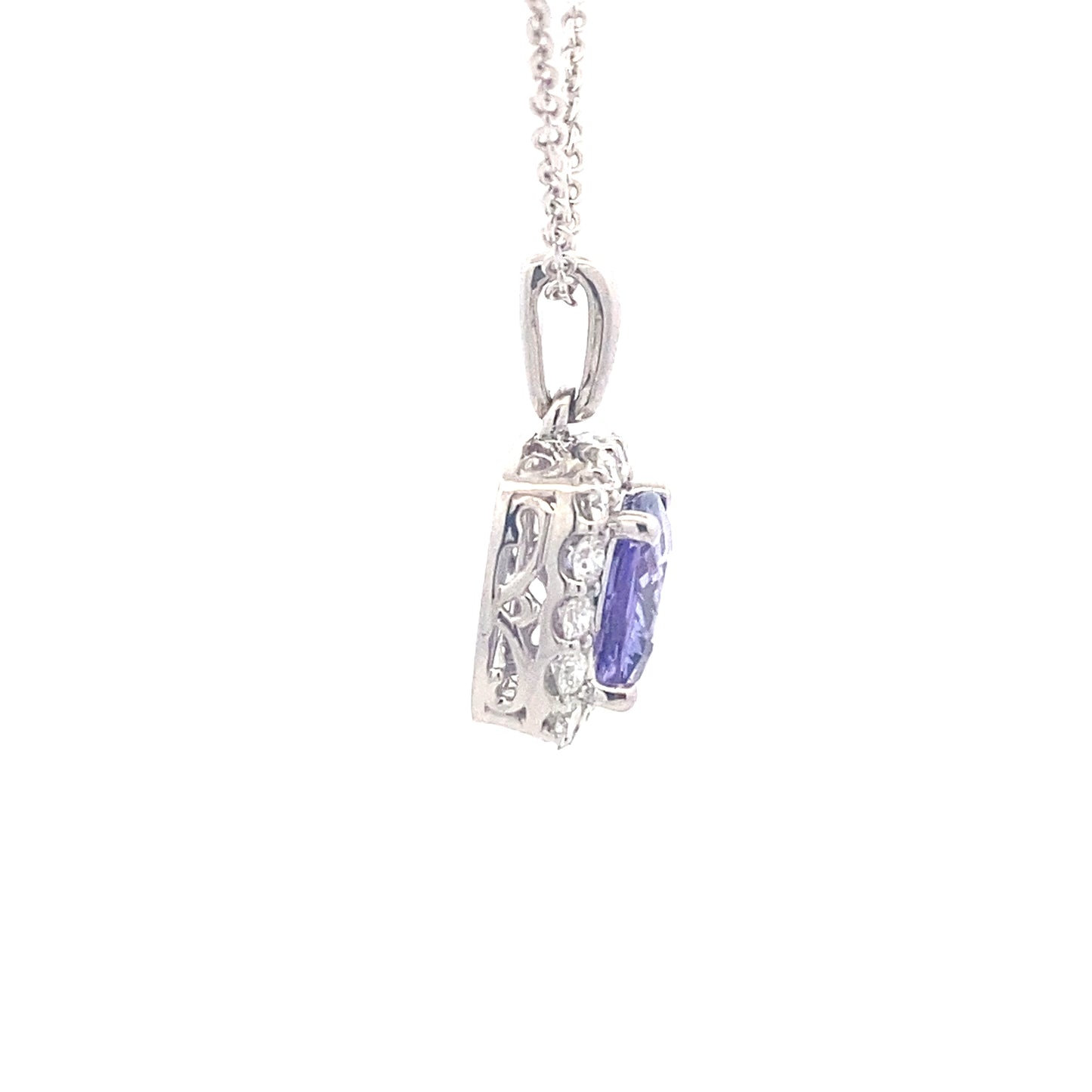 Cushion shaped Tanzanite and round brilliant cut diamond halo pendant Gardiner Brothers