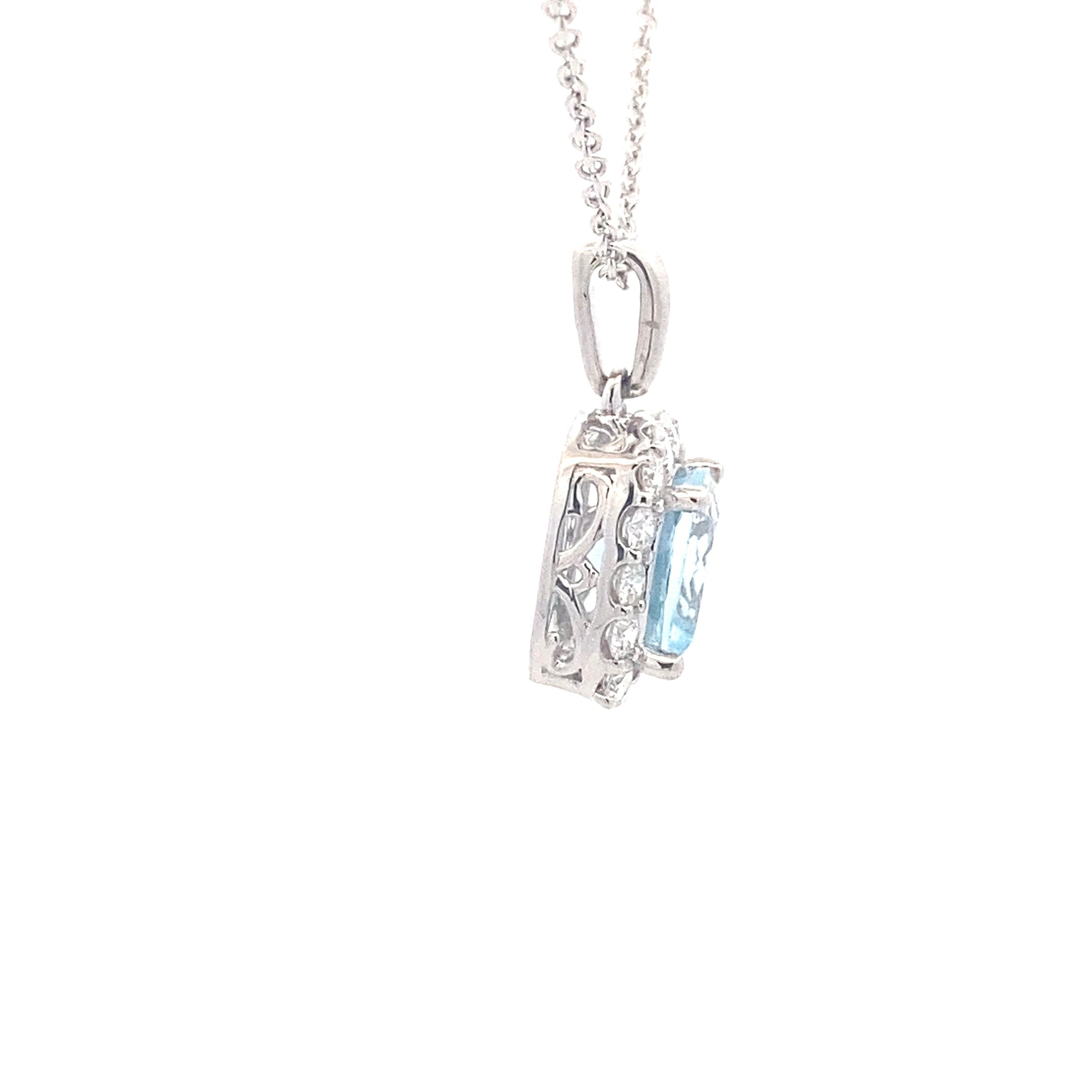Cushion shaped Aquamarine and round brilliant cut diamond halo pendant Gardiner Brothers
