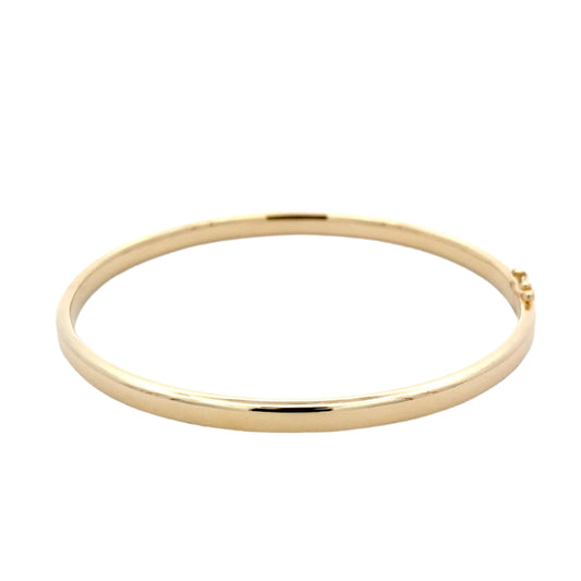 Yellow Gold 4mm solid bangle with a Court profile Gardiner Brothers