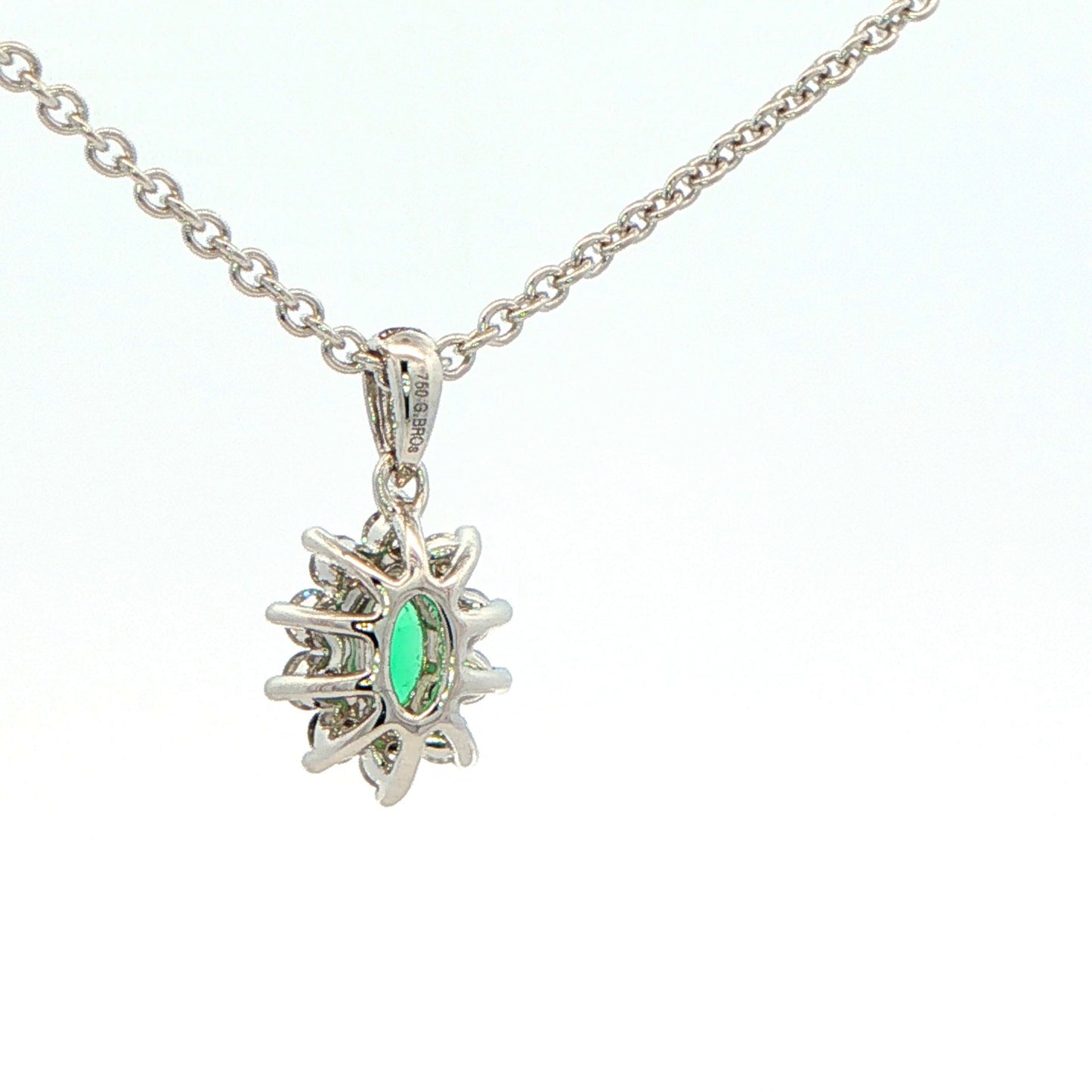 Oval Shaped emerald and round brilliant cut diamond cluster pendant Gardiner Brothers