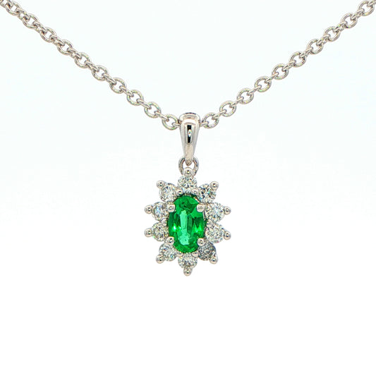Oval Shaped emerald and round brilliant cut diamond cluster pendant Gardiner Brothers