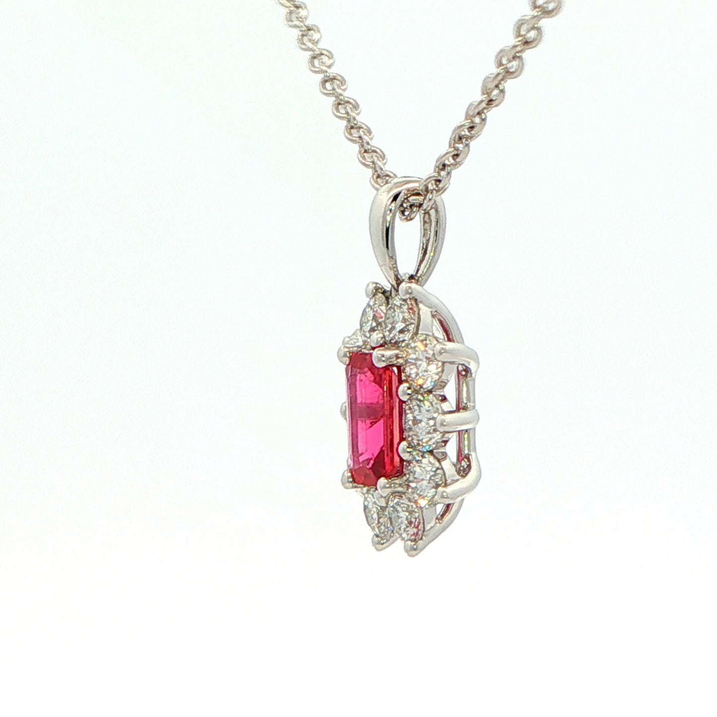 Octagonal shaped Ruby and round brilliant cut diamond cluster style pendant Gardiner Brothers