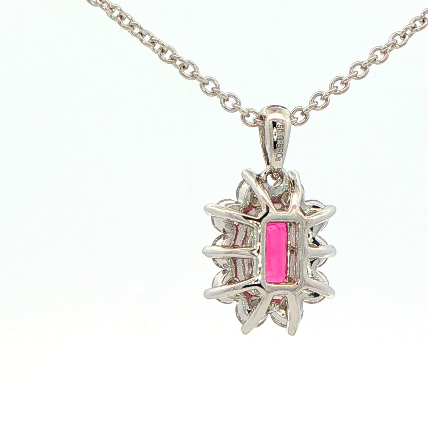 Octagonal shaped Ruby and round brilliant cut diamond cluster style pendant Gardiner Brothers