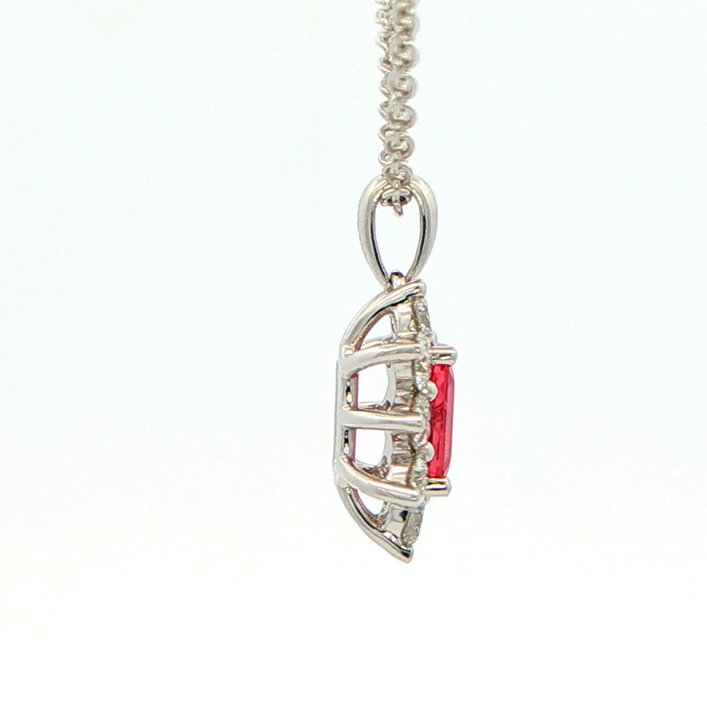 Octagonal shaped Ruby and round brilliant cut diamond cluster style pendant Gardiner Brothers
