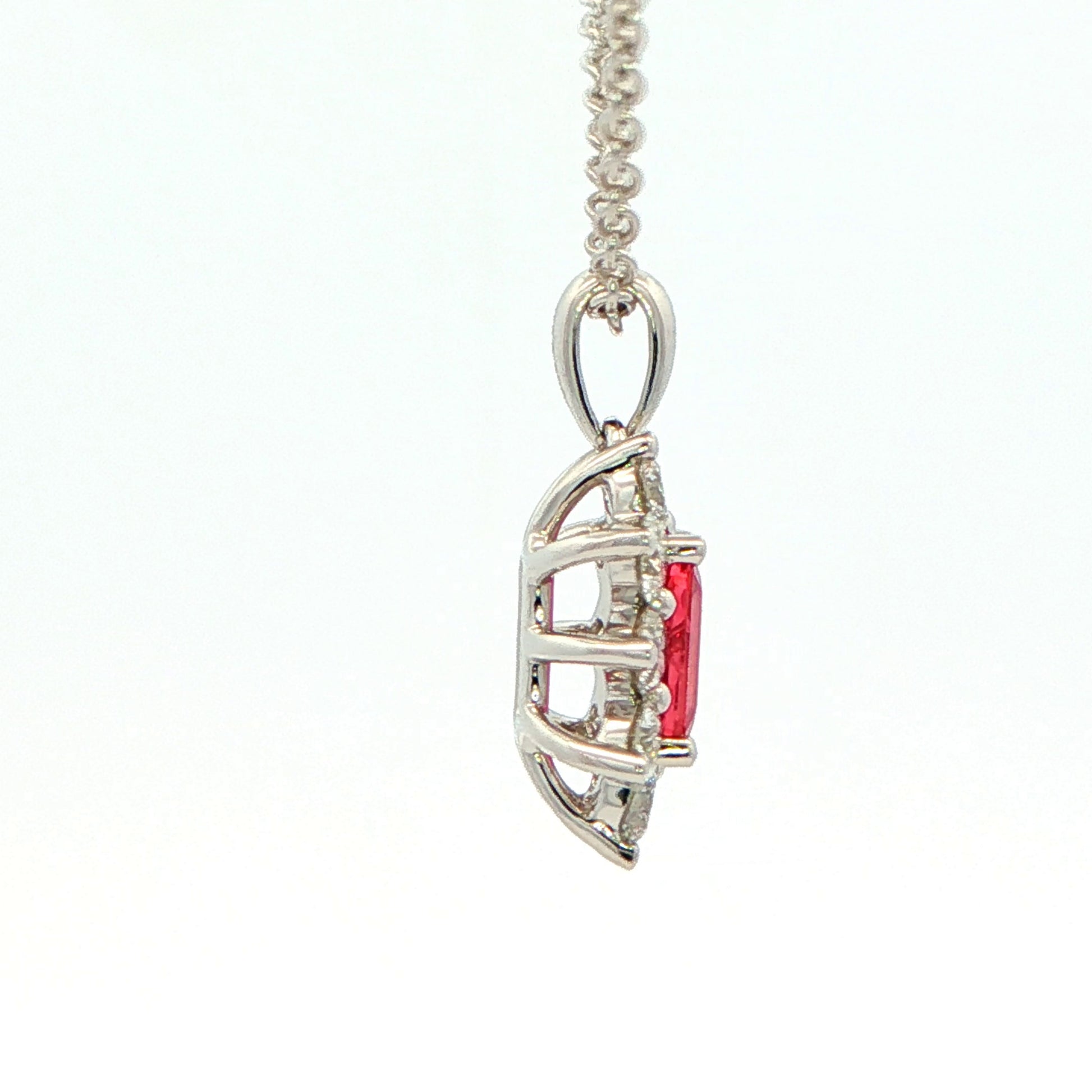 Octagonal shaped Ruby and round brilliant cut diamond cluster style pendant Gardiner Brothers