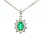 Oval shaped emerald and round brilliant cut diamond cluster pendant Gardiner Brothers
