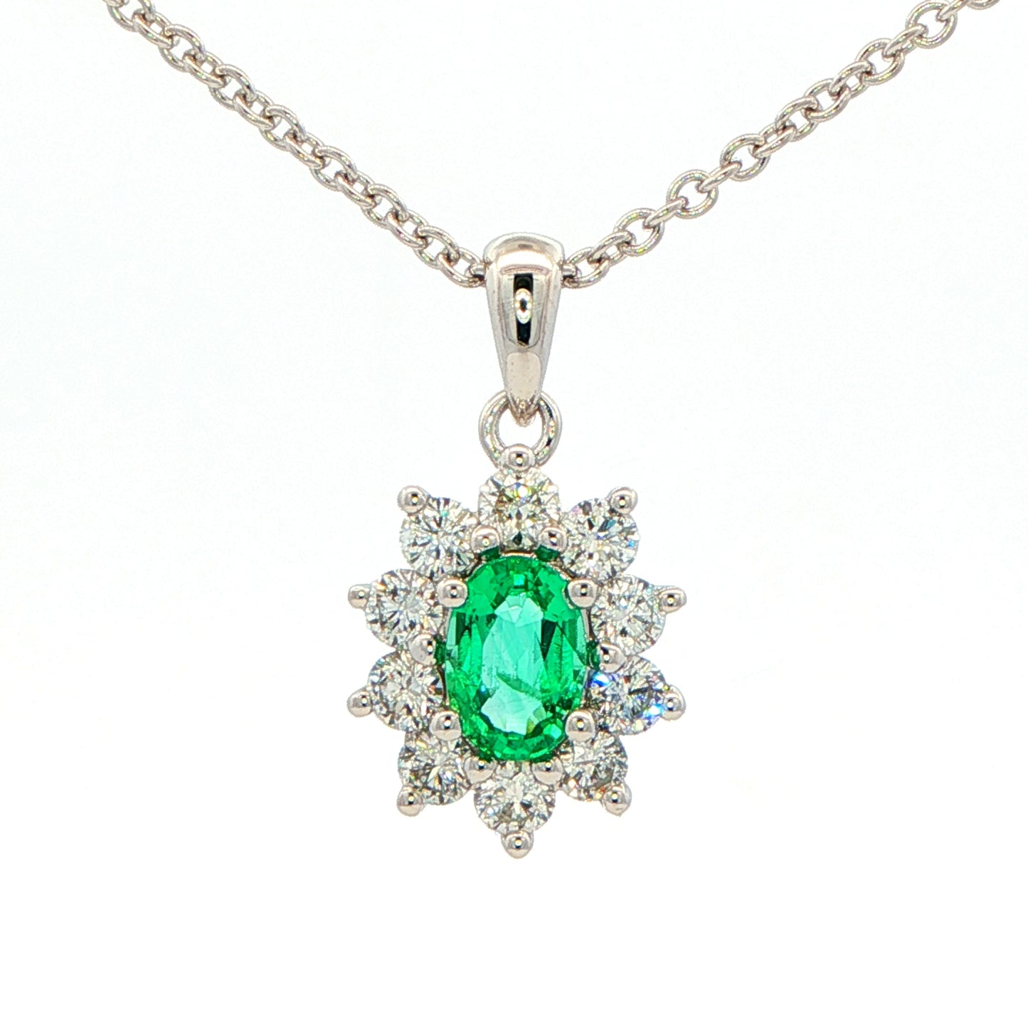 Oval shaped emerald and round brilliant cut diamond cluster pendant Gardiner Brothers