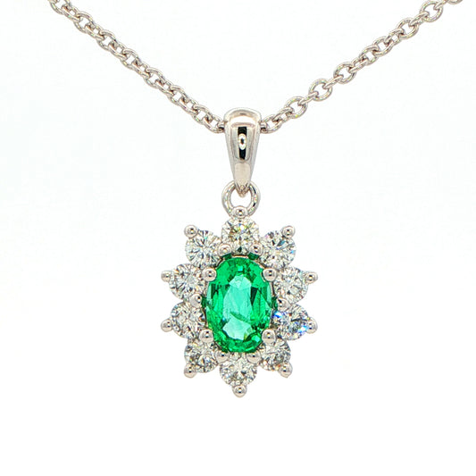 Oval shaped emerald and round brilliant cut diamond cluster pendant Gardiner Brothers