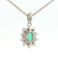 Oval shaped emerald and round brilliant cut diamond cluster pendant Gardiner Brothers