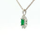 Octagonal shaped emerald and round brilliant cut diamond cluster pendant Gardiner Brothers