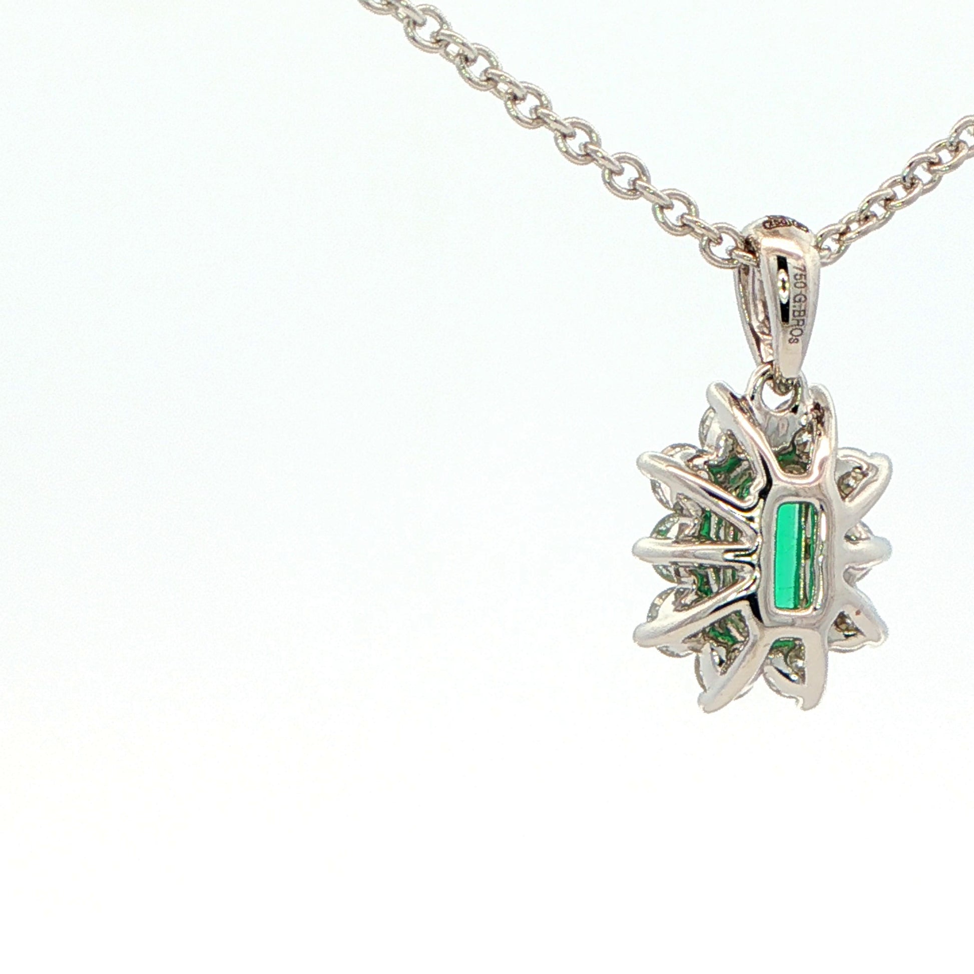 Octagonal shaped emerald and round brilliant cut diamond cluster pendant Gardiner Brothers