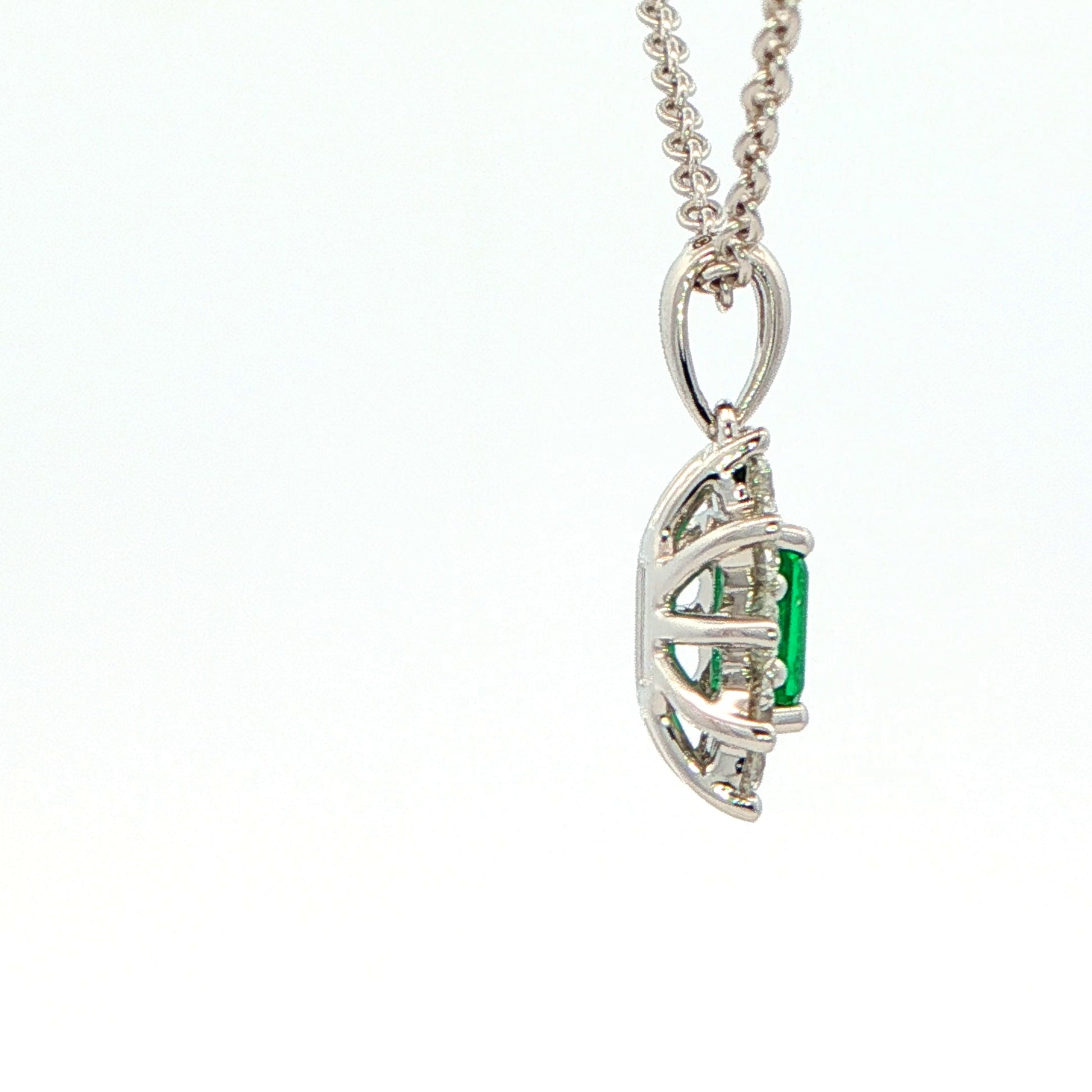 Octagonal shaped emerald and round brilliant cut diamond cluster pendant Gardiner Brothers