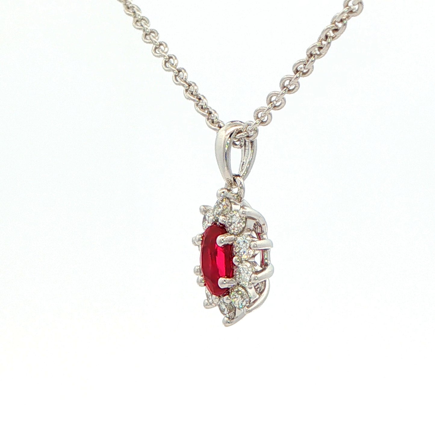 Oval shaped ruby and round brilliant cut diamond cluster style pendant Gardiner Brothers