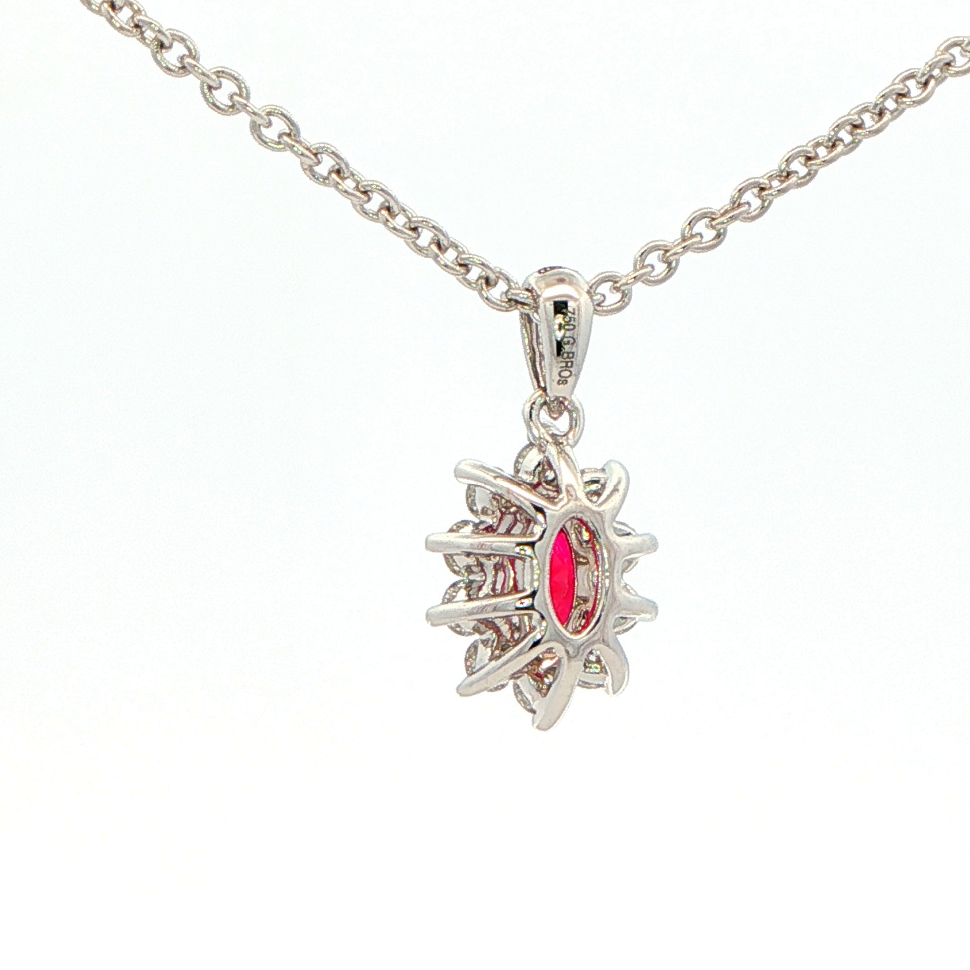 Oval shaped ruby and round brilliant cut diamond cluster style pendant Gardiner Brothers