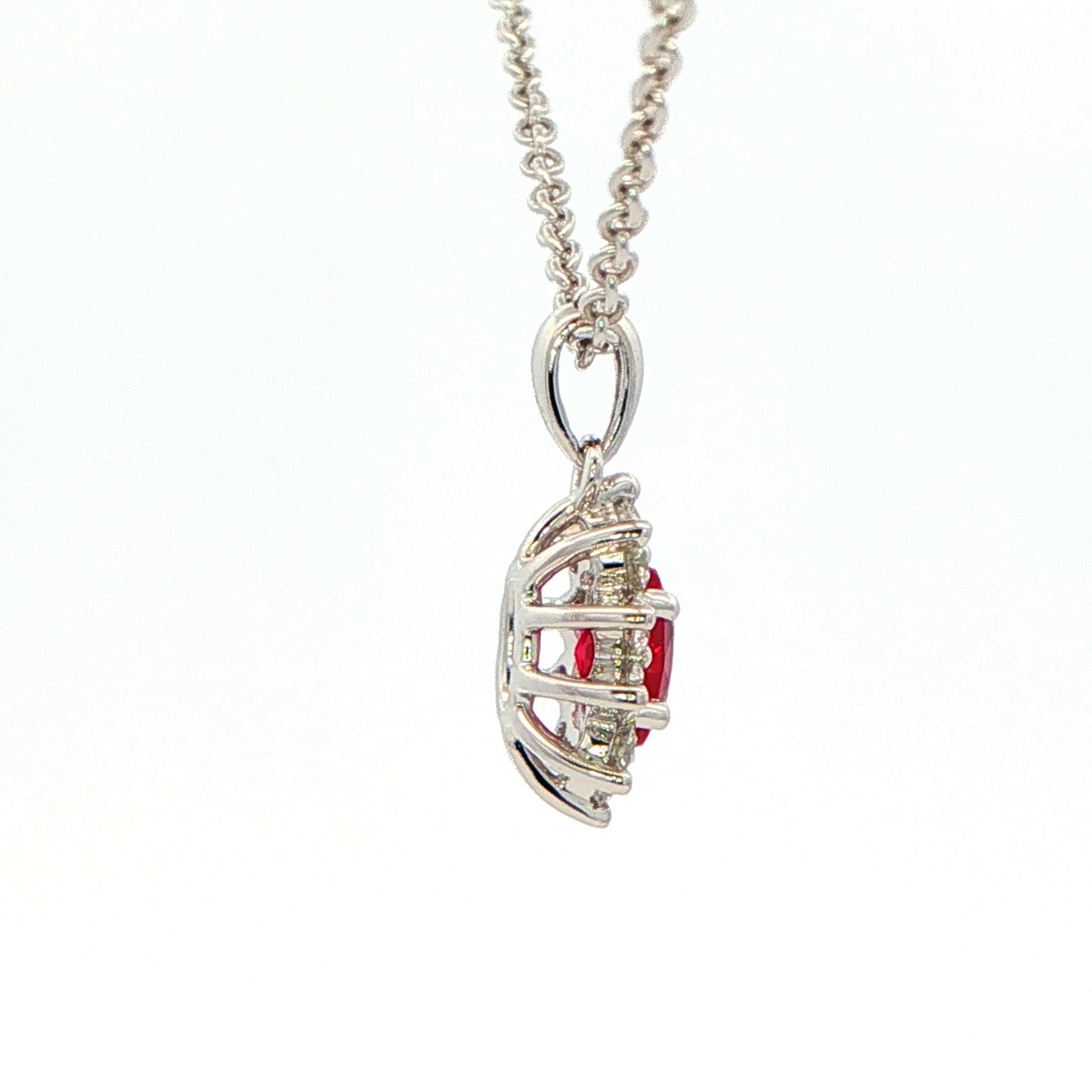 Oval shaped ruby and round brilliant cut diamond cluster style pendant Gardiner Brothers
