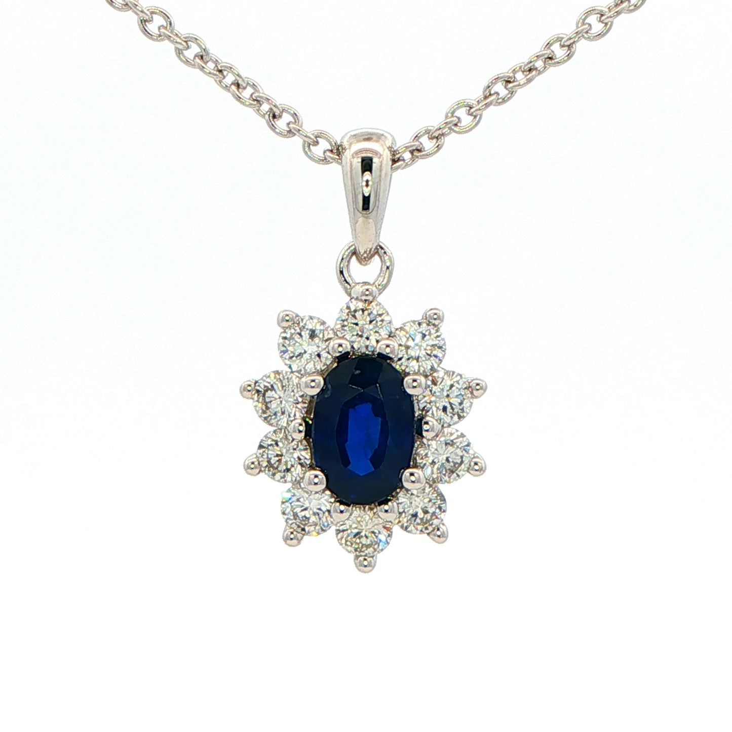Oval shaped sapphire and round brilliant cut diamond cluster style pendant Gardiner Brothers