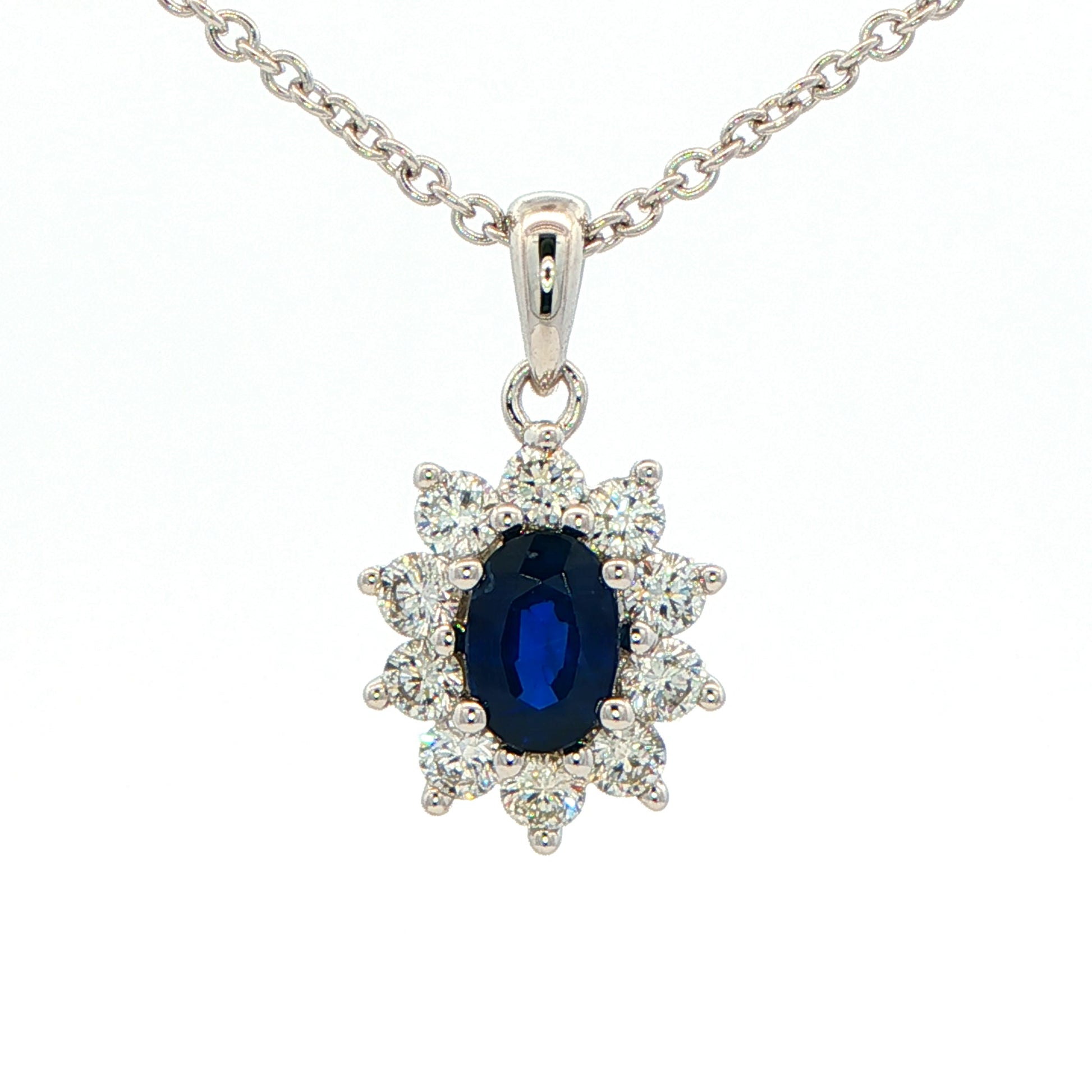 Oval shaped sapphire and round brilliant cut diamond cluster style pendant Gardiner Brothers